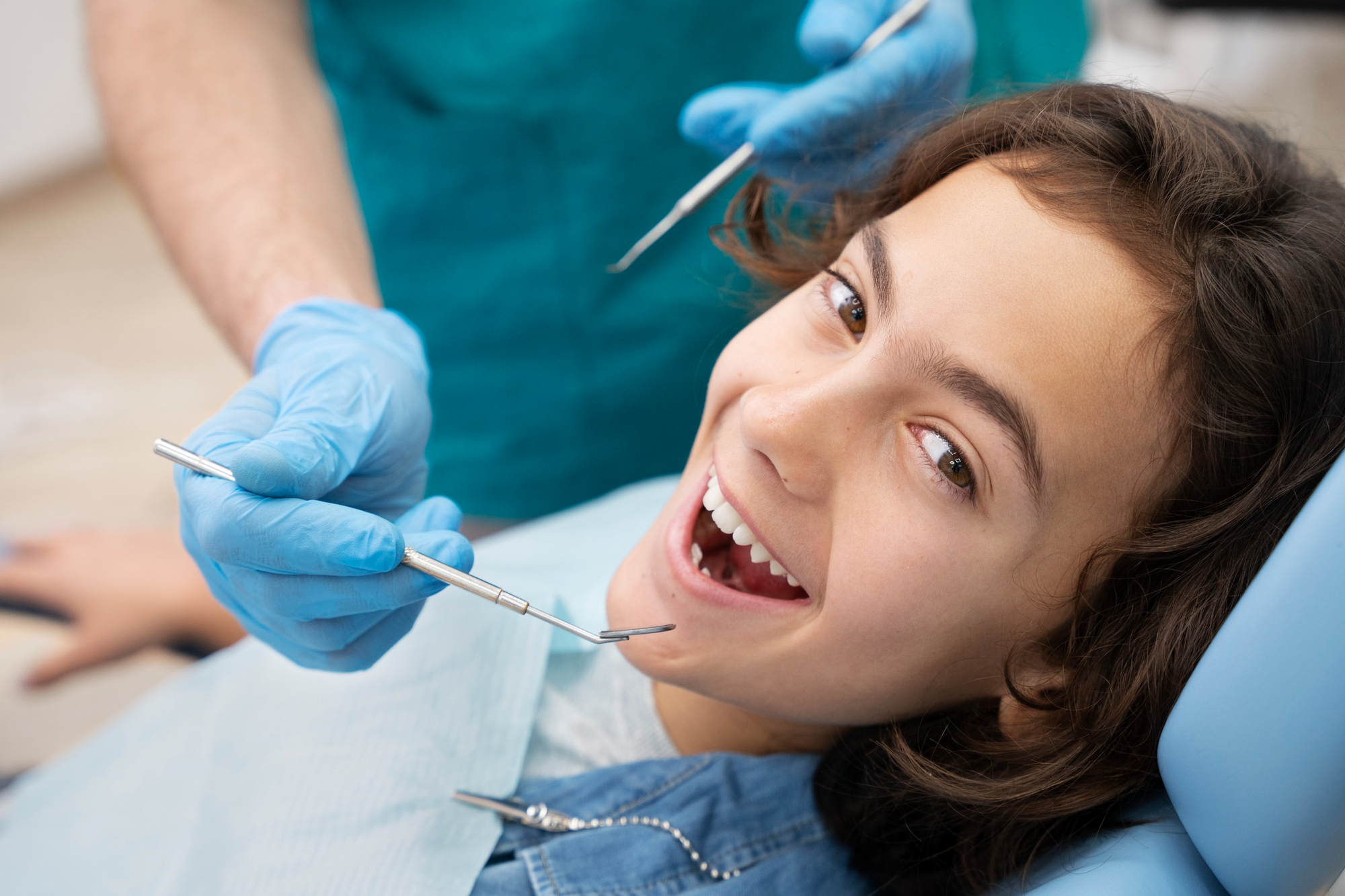 Friendly dentist providing a gentle, reassuring dental checkup for a child